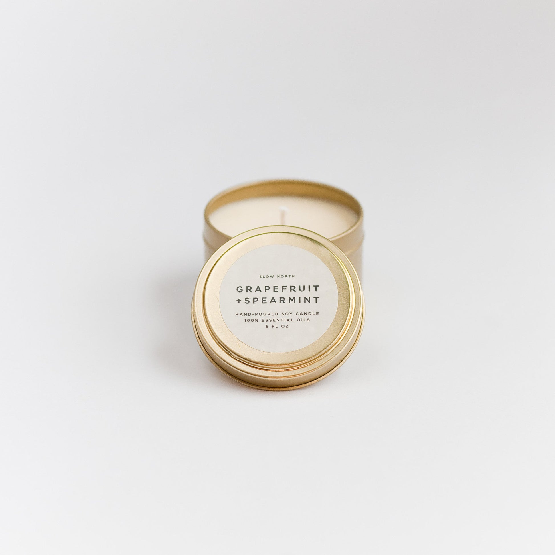 Grapefruit + Spearmint soy wax candle in 6 ounce gold travel tin by Slow North