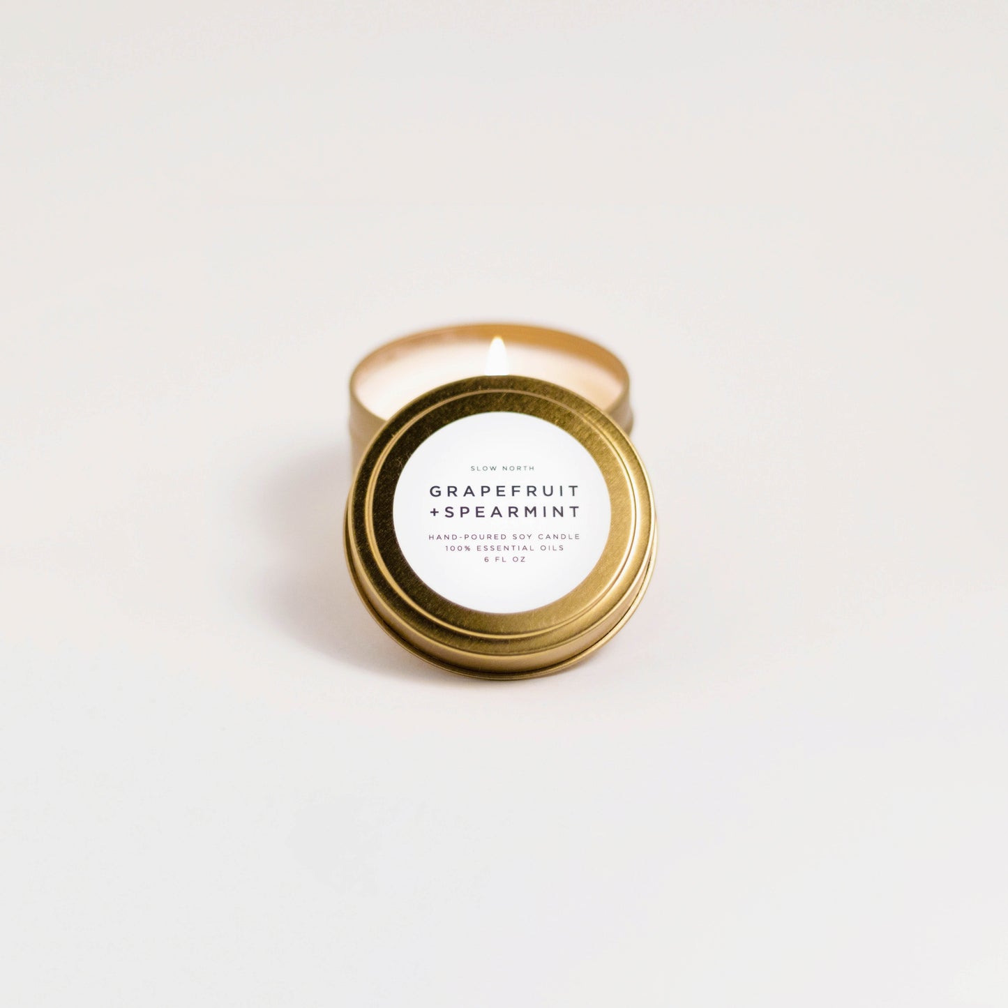 Grapefruit + Spearmint soy wax candle in 6 ounce gold travel tin by Slow North