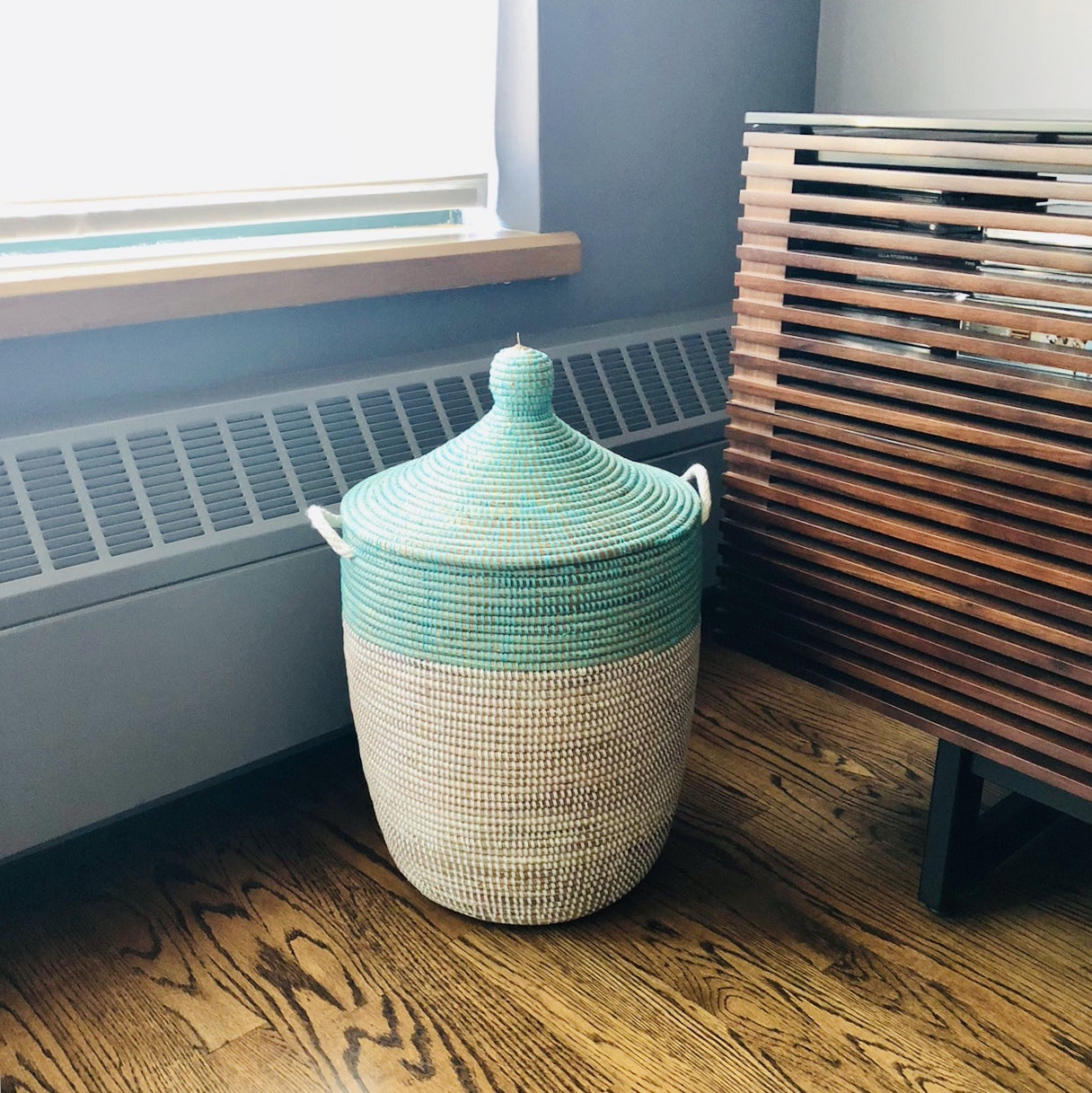 Turquoise and white medium two tone basket in a home