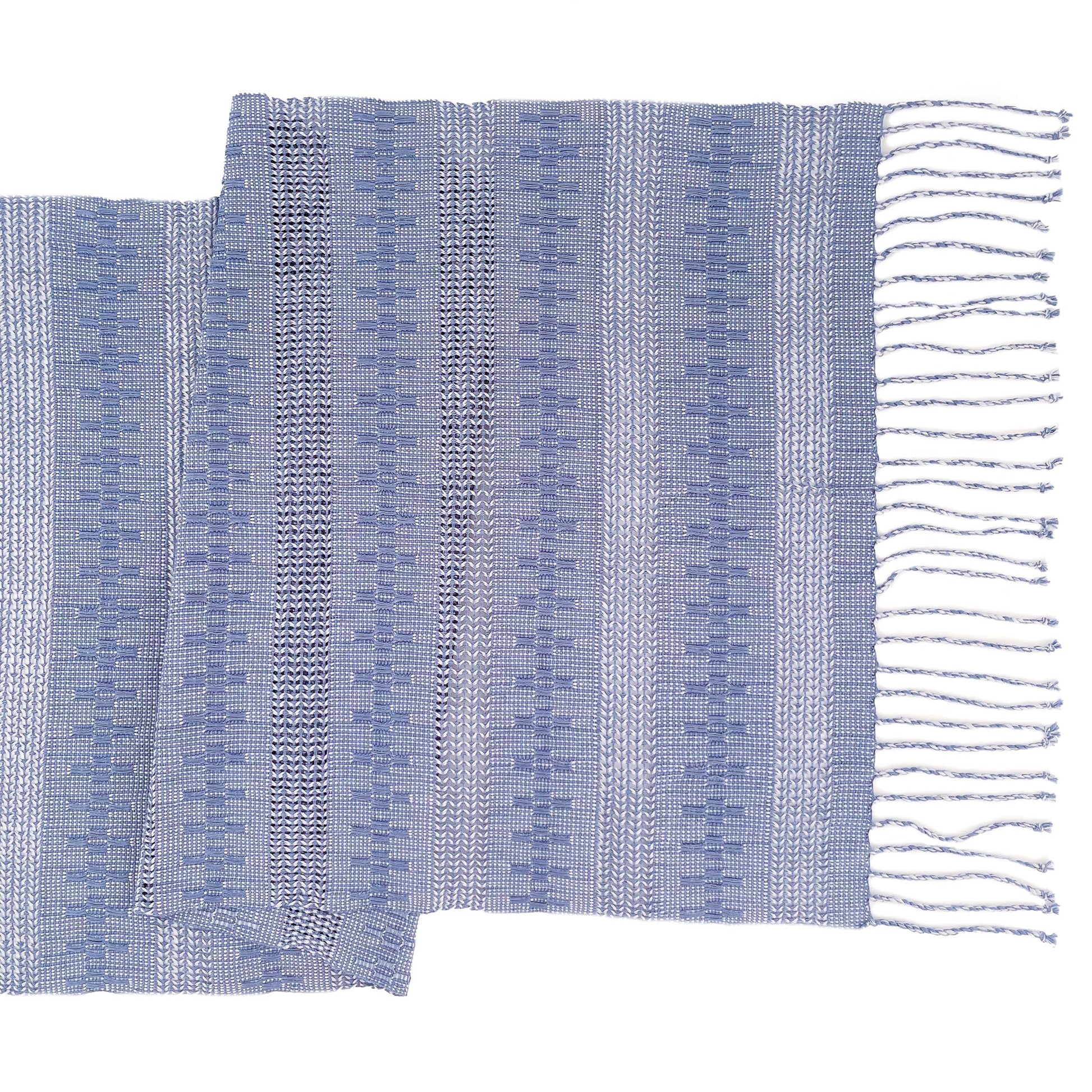 Overhead view of the Calado Table Runner in Blue with twisted fringe