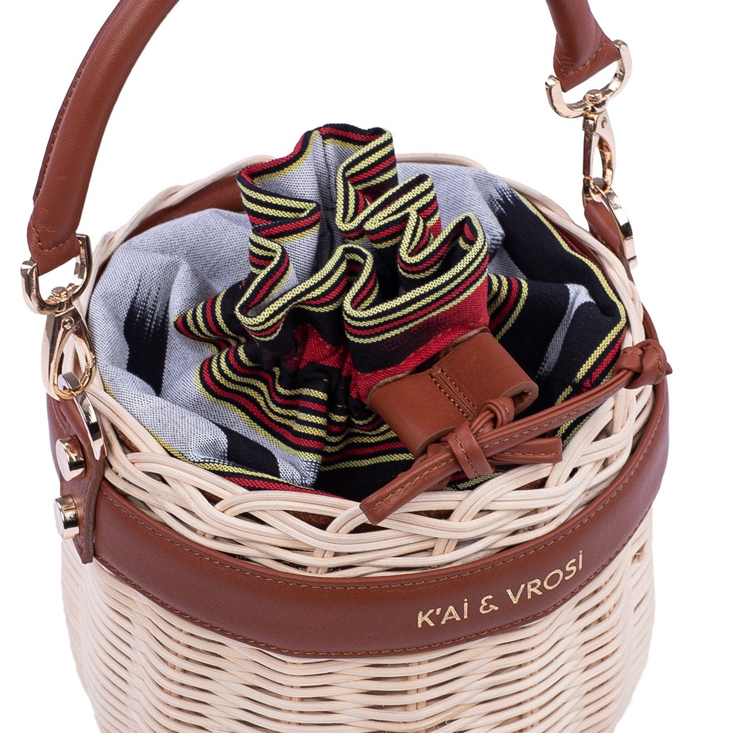 Okordule brown, round shaped woven rattan handbag with leather top handle. drawstring at the top.